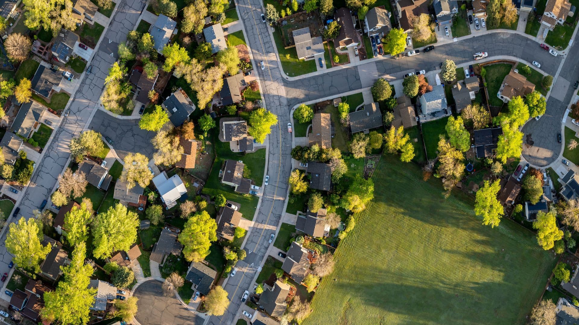 An aerial view of a residential area with lots of houses and trees.