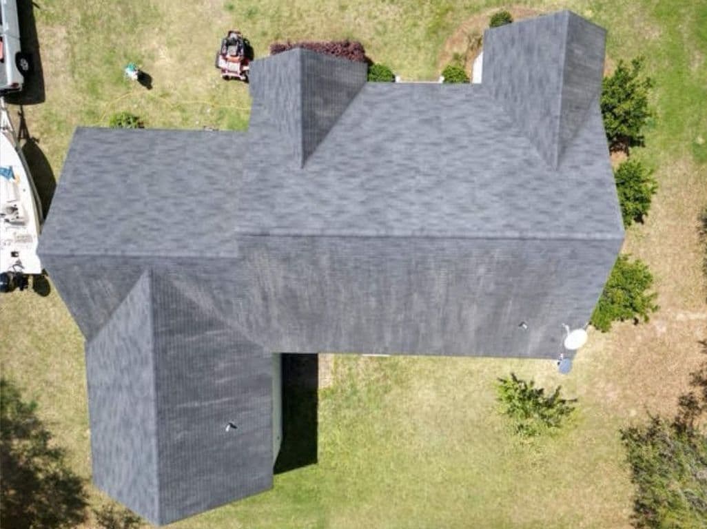 Aerial view of a house roof before roof rejuvenation treatment
